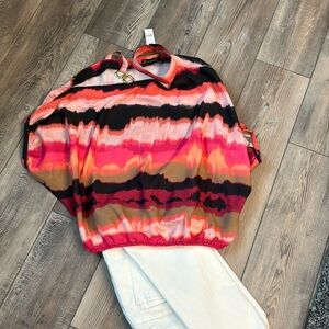 Cold shoulder blouse with asymmetrical neckline.